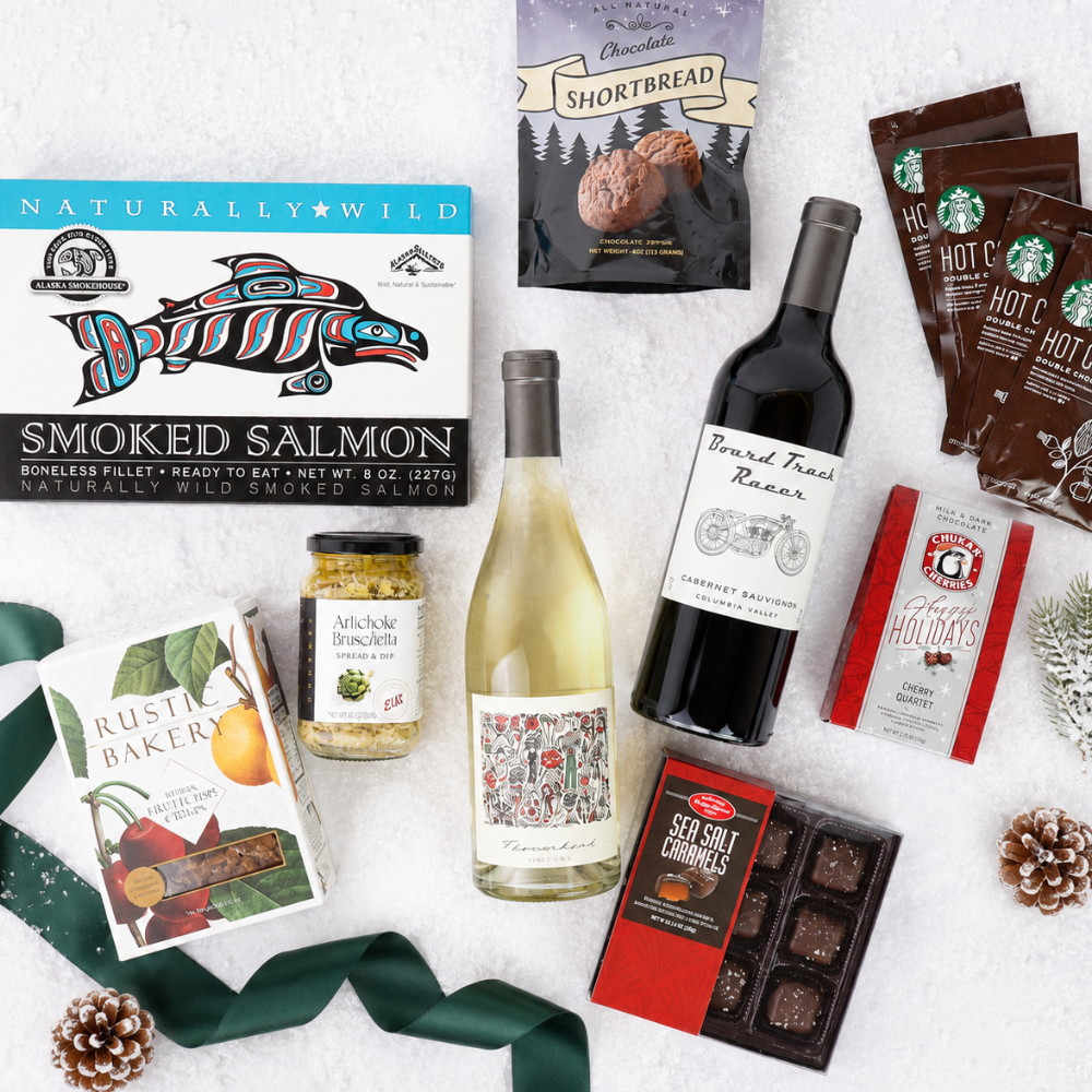 flat lay of gift basket contents including two bottles of wine, smoked salmon, chocolates and cookies